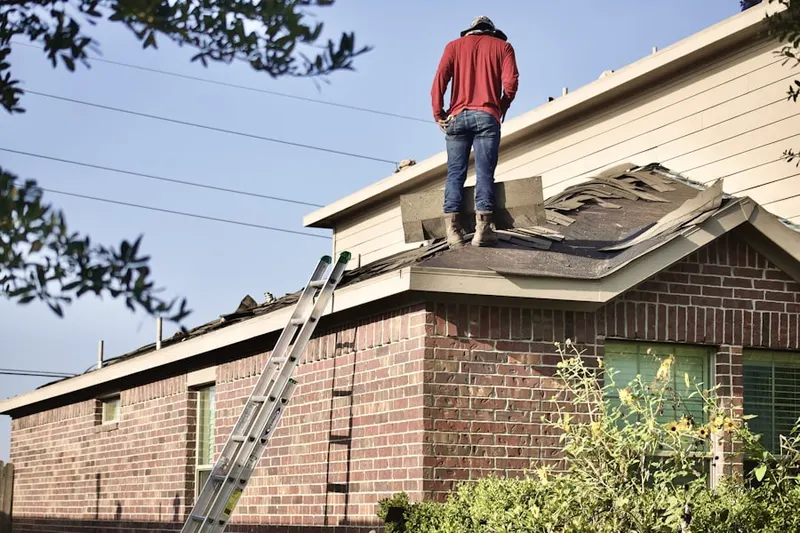 Professional roofer working on a residential roof in Rantoul